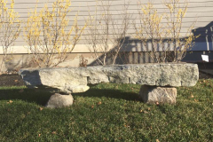 A natural stone bench creates a place to take in the view.