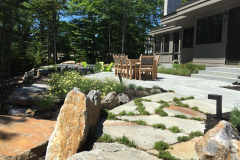 The patio dining area is softened with billowy masses of perennials.