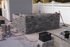 The natural stacked-stone veneer is installed.