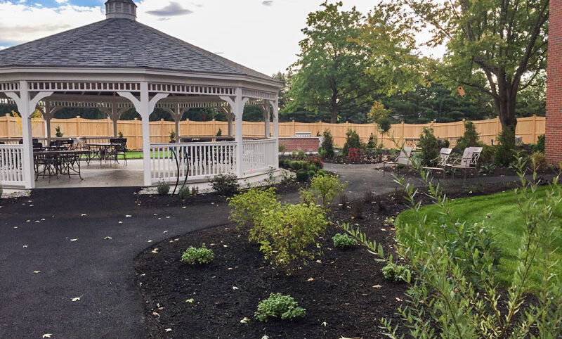 minimal garden and walkway near a gazebo in a maine commercial landscape setting